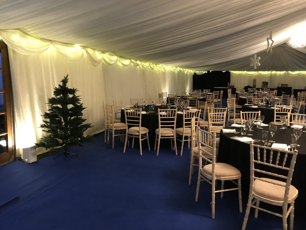 Uplighters and fairy lights in a clearspan corporate marquee