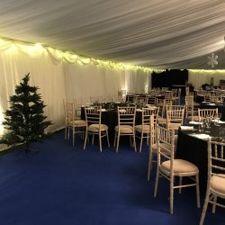 Uplighters and fairy lights in a clearspan corporate marquee