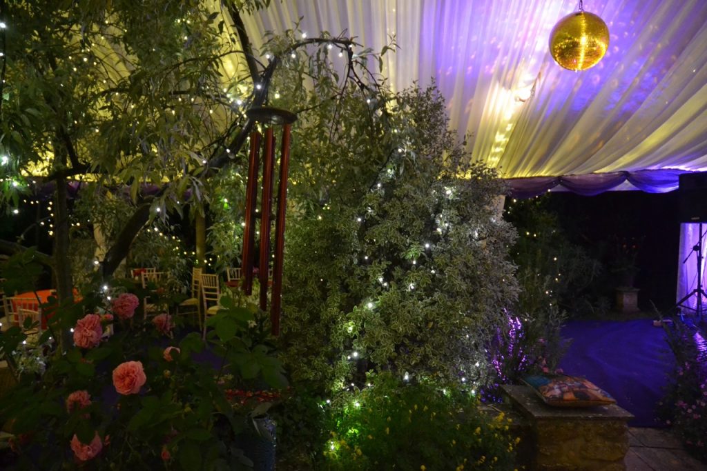 Gold mirror ball with spotlights in a clearspan party marquee