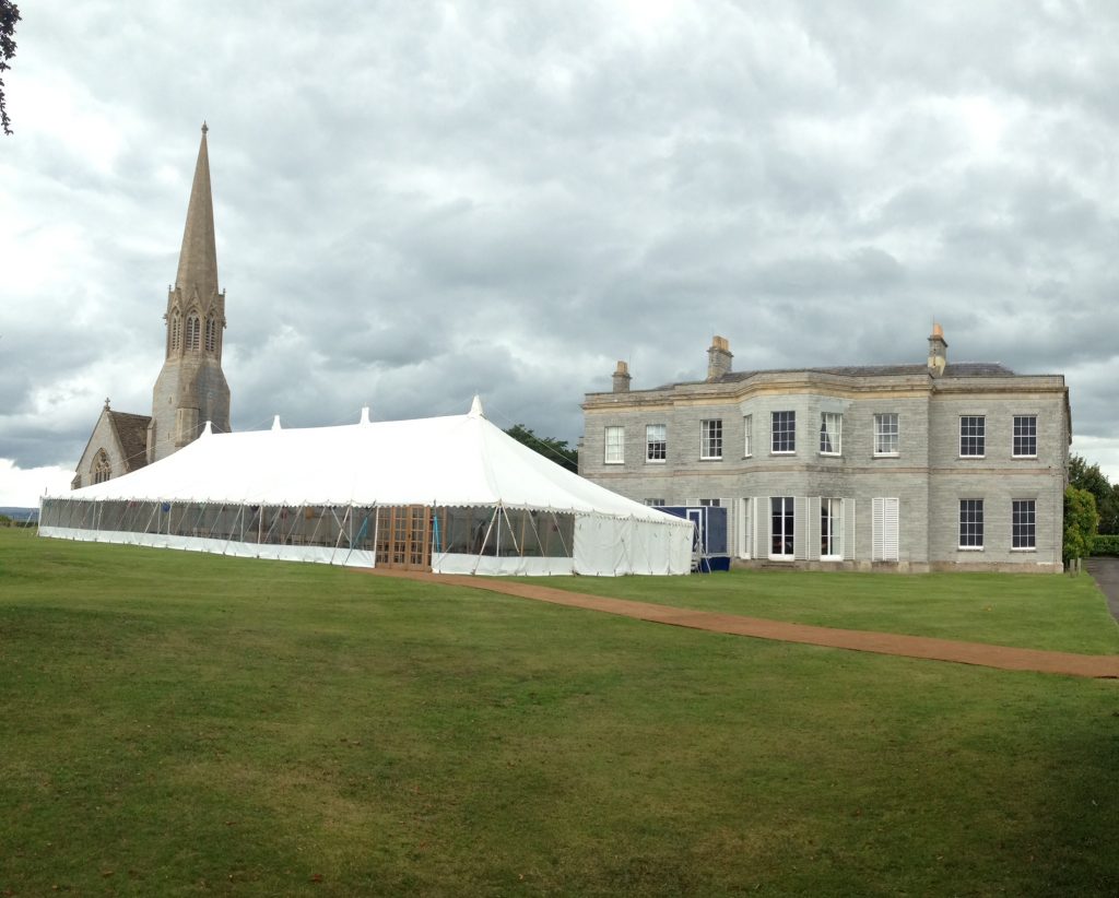 Traditional marquee with double doors and a coconut matting pathway built for a summer wedding in Somerset by Archers Marquees