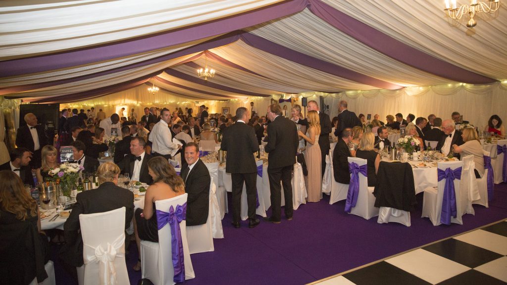 Chandeliers, uplighters and fairy lights in a clearspan corporate marquee