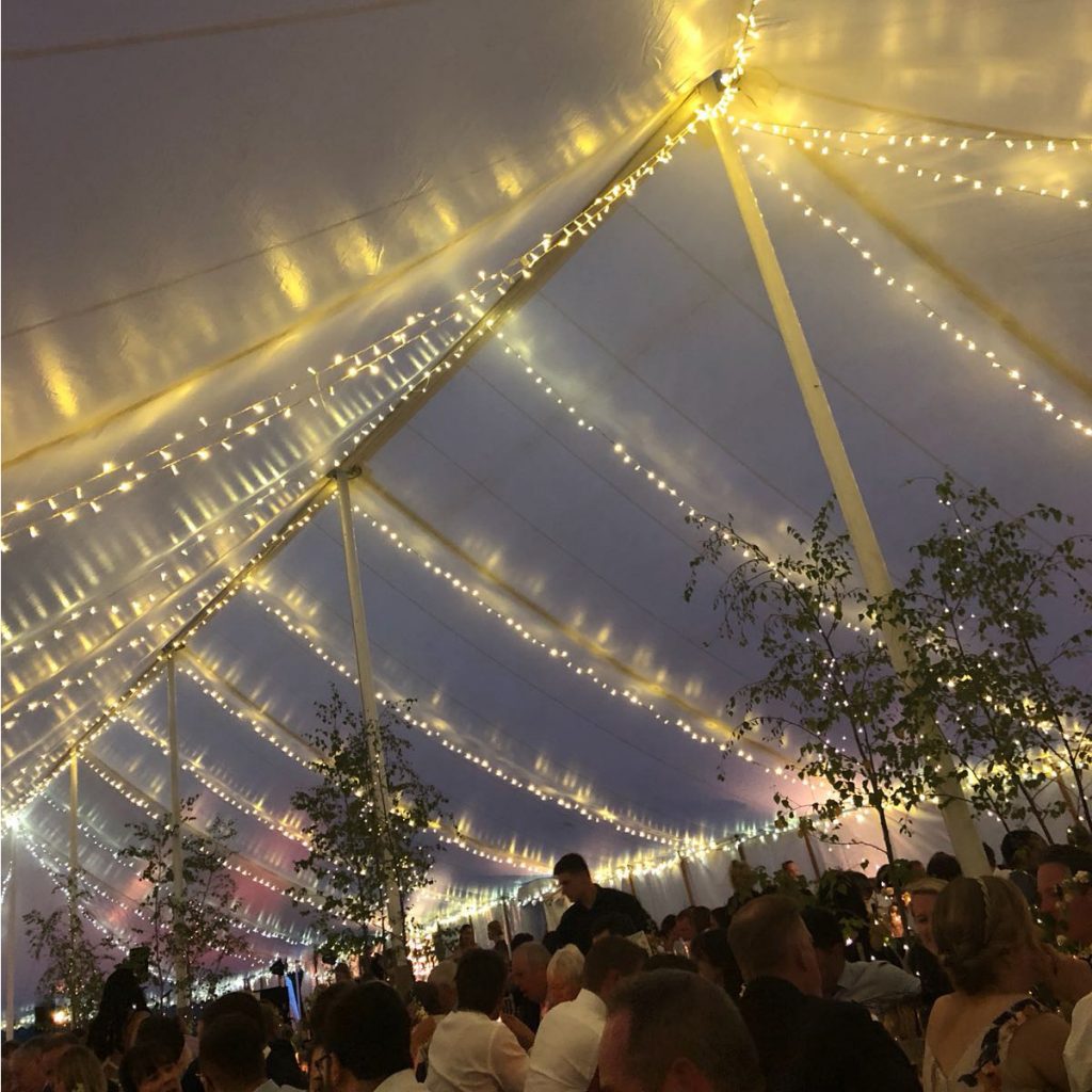 Fairy lights hung in the roof of a traditional wedding marquee built by Archers Marquees for a wedding near Bristol