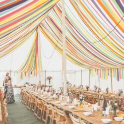 Colourful Streamers inside a traditional marquee, built by Archers Marquees