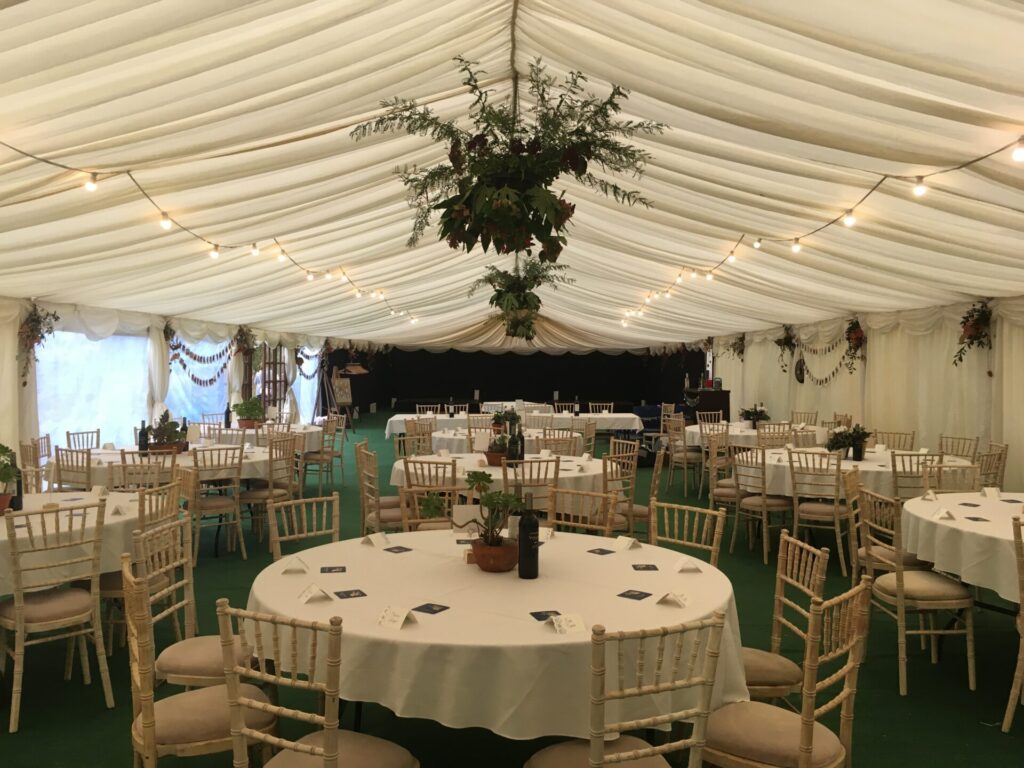 Pleated ivory lining in a clearspan marquee