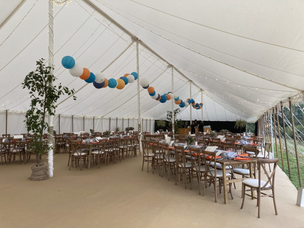 Coloured paper lanterns in an unlined traditional marquee