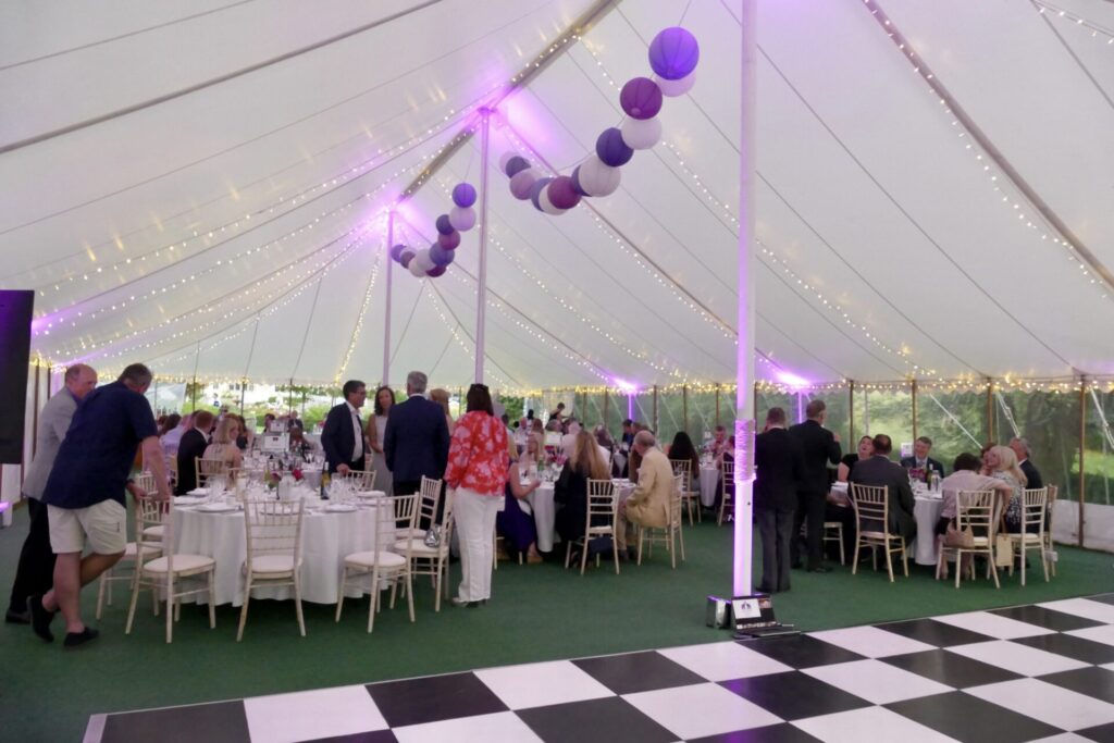 Coloured paper lanterns in an unlined traditional marquee